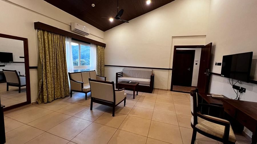 Royal Suite with a seating area and a wide window at Mastiff Grand La Villae Resort, Lonavala